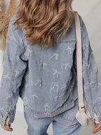 Women’s light wash raw hem denim jacket with bow knot print, featuring a classic denim style and casual fit.