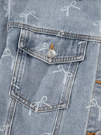 Woman wearing a light wash denim jacket with bow knot print, raw hem, and casual fit from Trendsi.