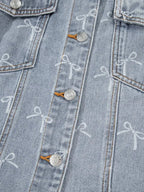 Women's light wash denim jacket with bow knot print and raw hem, stylish Trendsi denim jacket for casual wear.