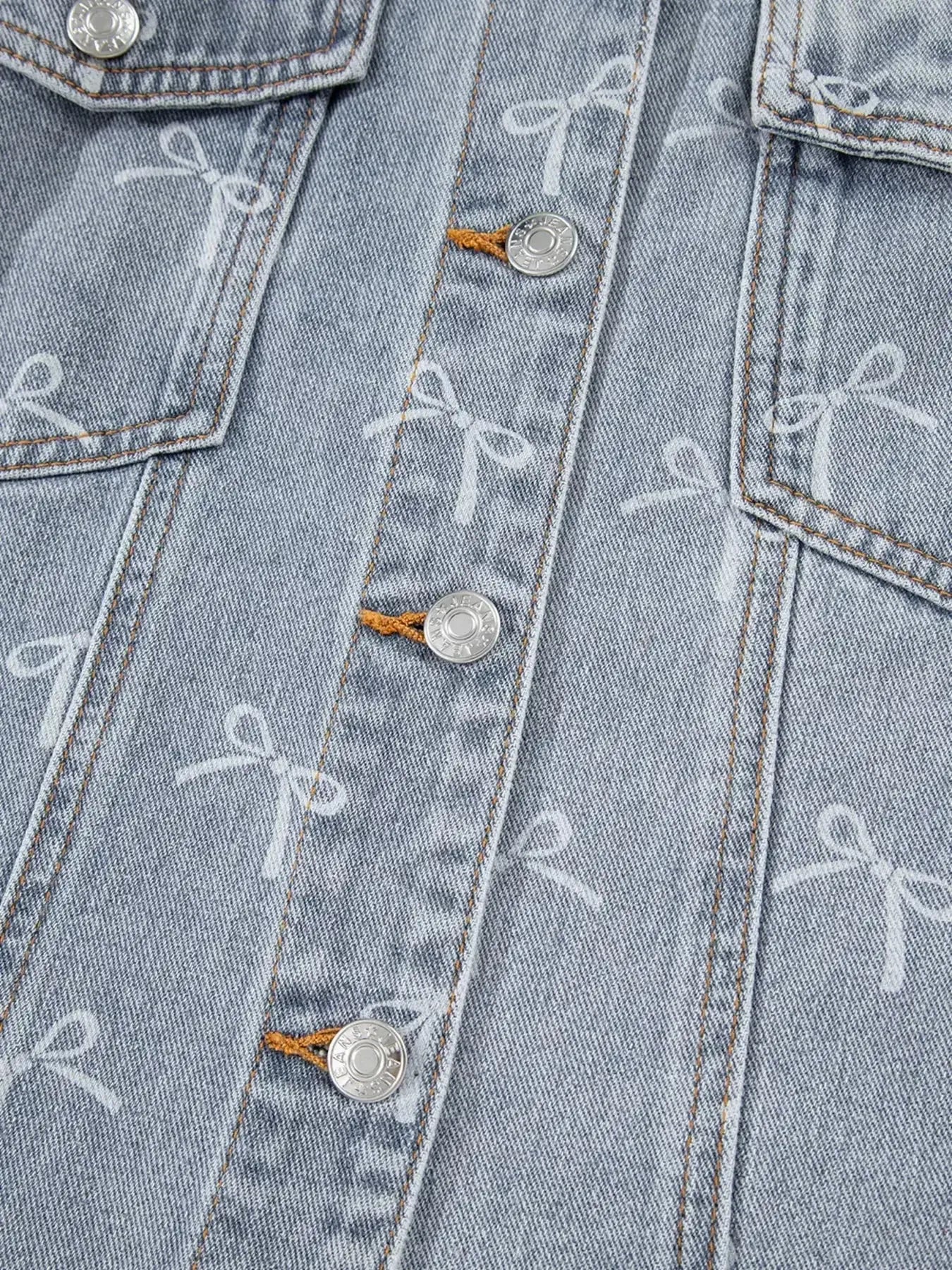 Women's light wash denim jacket with bow knot print and raw hem, stylish Trendsi denim jacket for casual wear.