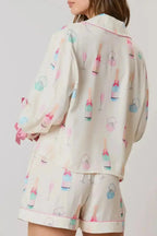 Women’s bow print collared lounge top and drawstring shorts pajama set by Trendsi, featuring comfortable fabric and relaxed fit.