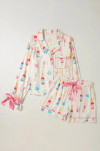 Women’s bow print collared lounge top and drawstring shorts pajama set from Trendsi, featuring a comfortable, stylish pajama ensemble.