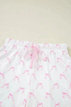 Women's bow print lounge set by Trendsi featuring soft pajamas with lettuce trim and matching shorts.