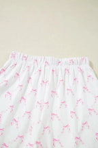 Women's bow print lounge set by Trendsi featuring lettuce trim, soft pajama top and shorts for comfortable wear.