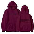 Women’s brushed fleece hoodie with letter graphic from Plush Fashion Hub, soft, oversized pullover for casual comfort.