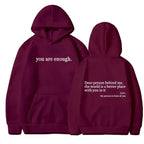 Women's brushed fleece hoodie with letter graphic from Plush Fashion Hub, soft oversized pullover in cozy fabric.
