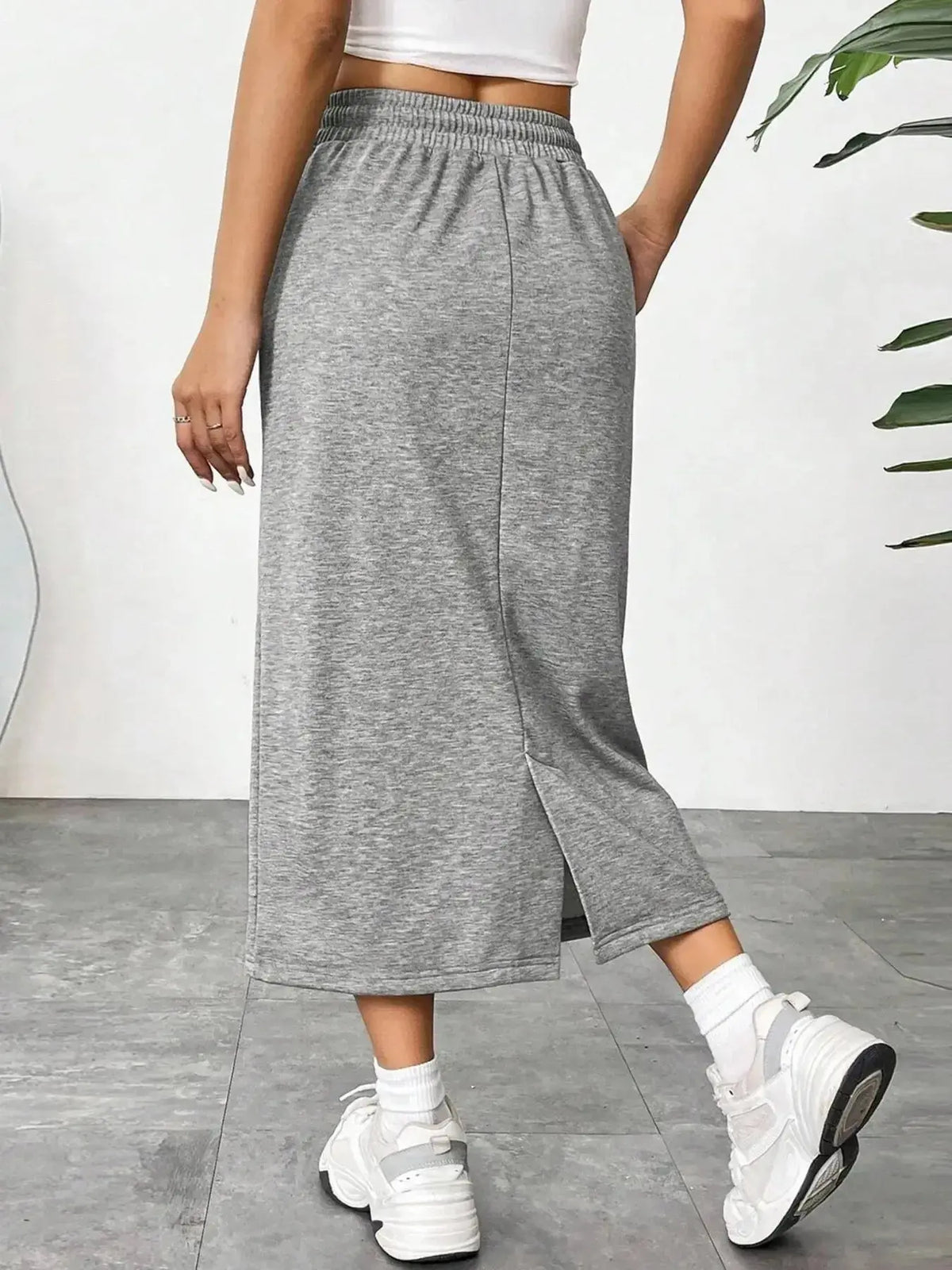 Women’s casual drawstring midi skirt with pockets and side slit, by Plush Fashion Hub, shown styled with a relaxed top.