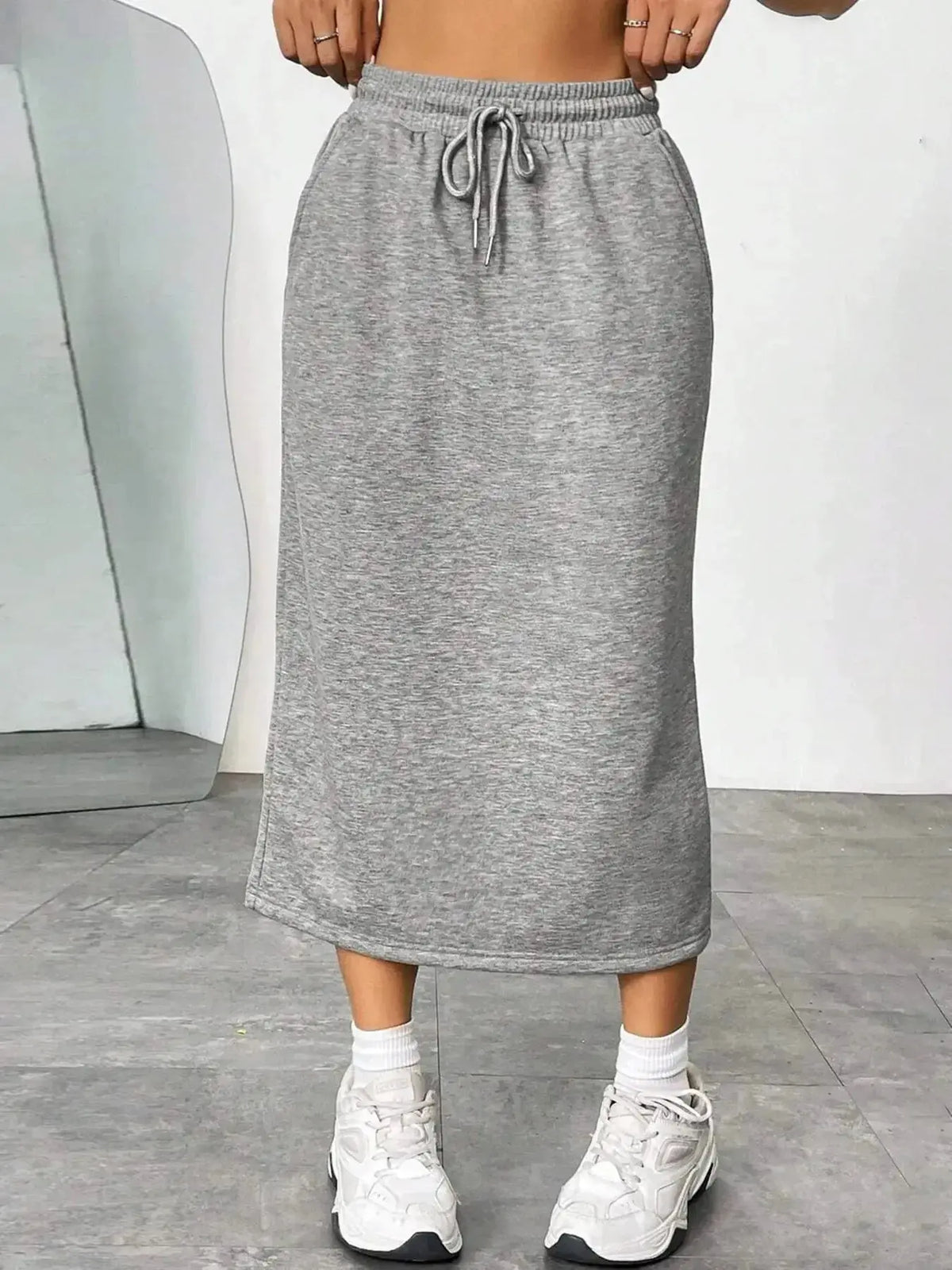 Women’s casual drawstring midi skirt with pockets and side slit by Plush Fashion Hub, featuring a relaxed fit and stylish design.