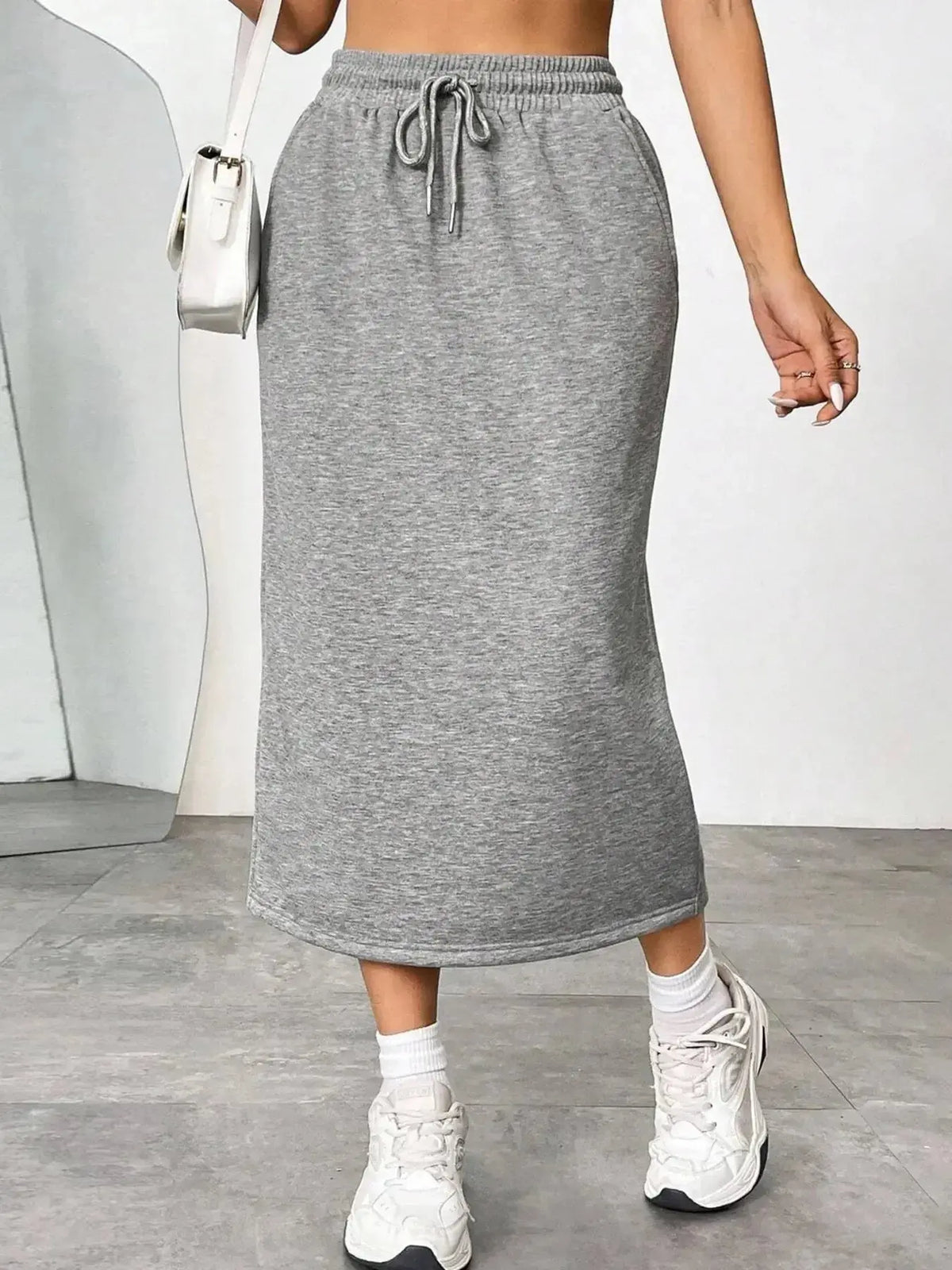 Women’s casual drawstring midi skirt with pockets and side slit, by Plush Fashion Hub, featuring a relaxed, stylish design.