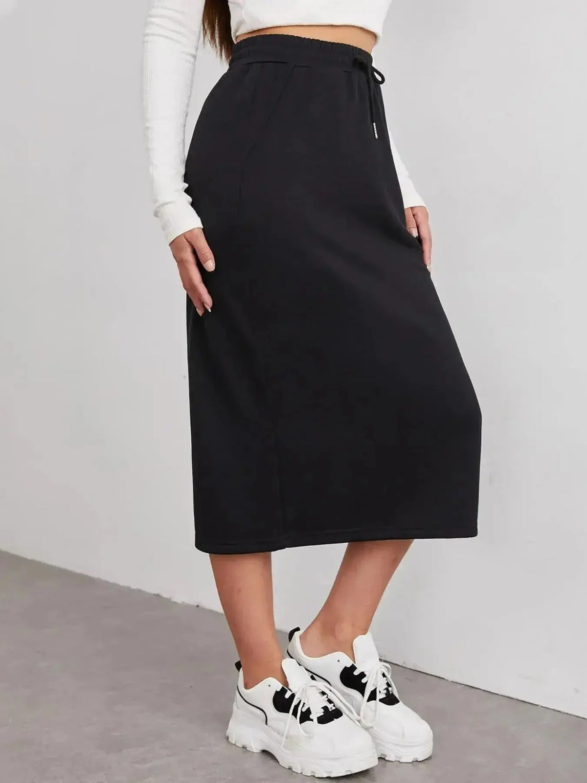 Women’s casual drawstring midi skirt with pockets and side slit, from Plush Fashion Hub, shown in a relaxed, stylish fit.