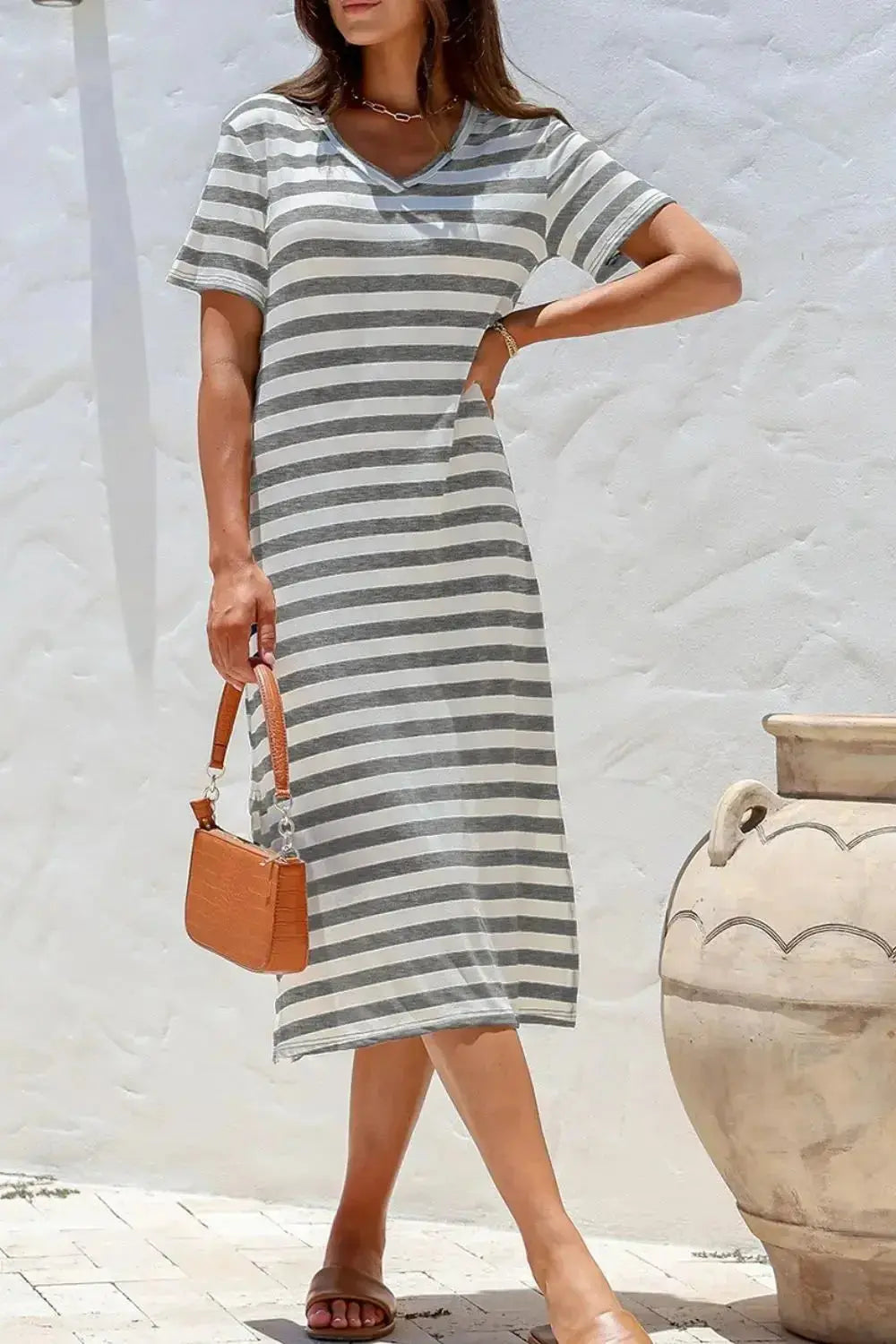 Women’s casual striped V-neck midi T-shirt dress by Trendsi, featuring a relaxed fit and soft fabric for comfortable everyday wear.