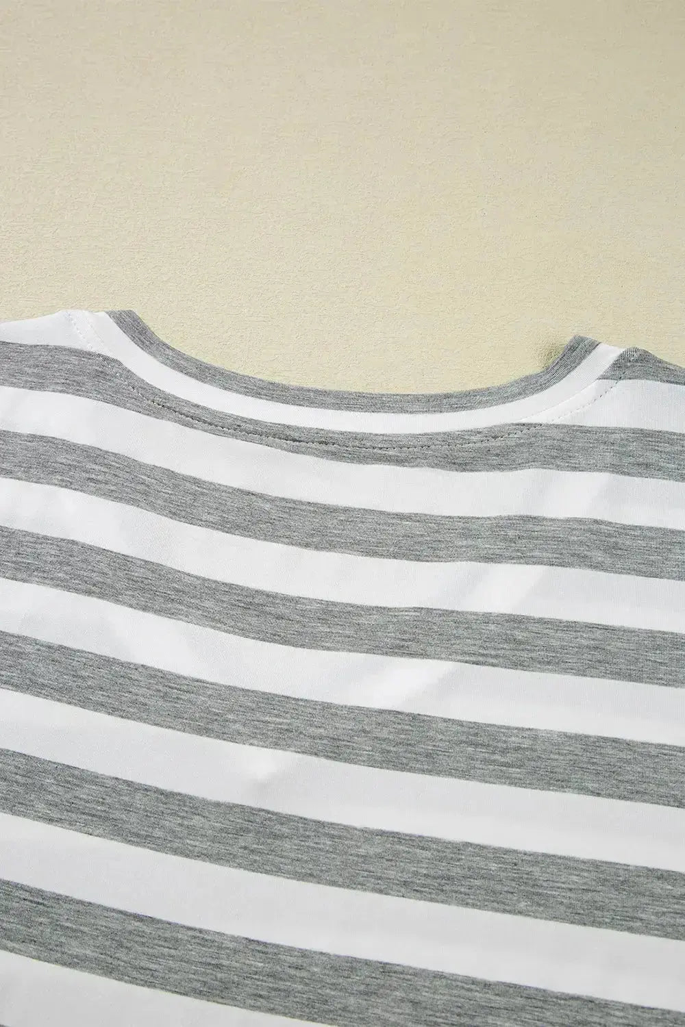 Women’s casual striped V-neck midi T-shirt dress by Trendsi, featuring a relaxed fit and comfortable fabric, styled for everyday wear.