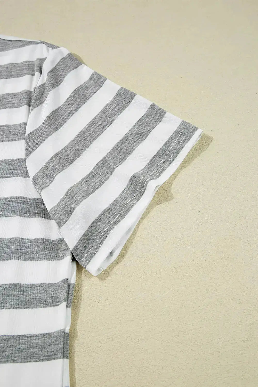 Women's casual striped V-neck midi T-shirt dress by Trendsi, featuring a comfortable fit and stylish design in soft fabric.