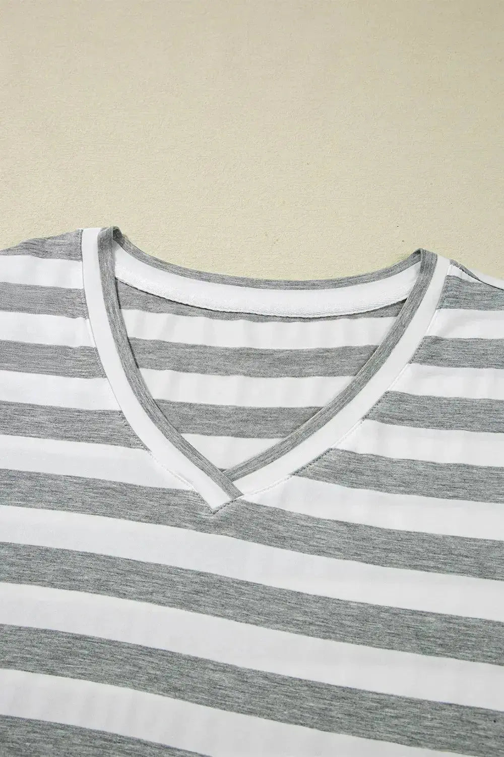 Women's casual striped V-neck midi T-shirt dress by Trendsi, featuring a comfortable fit and stylish design in soft fabric.