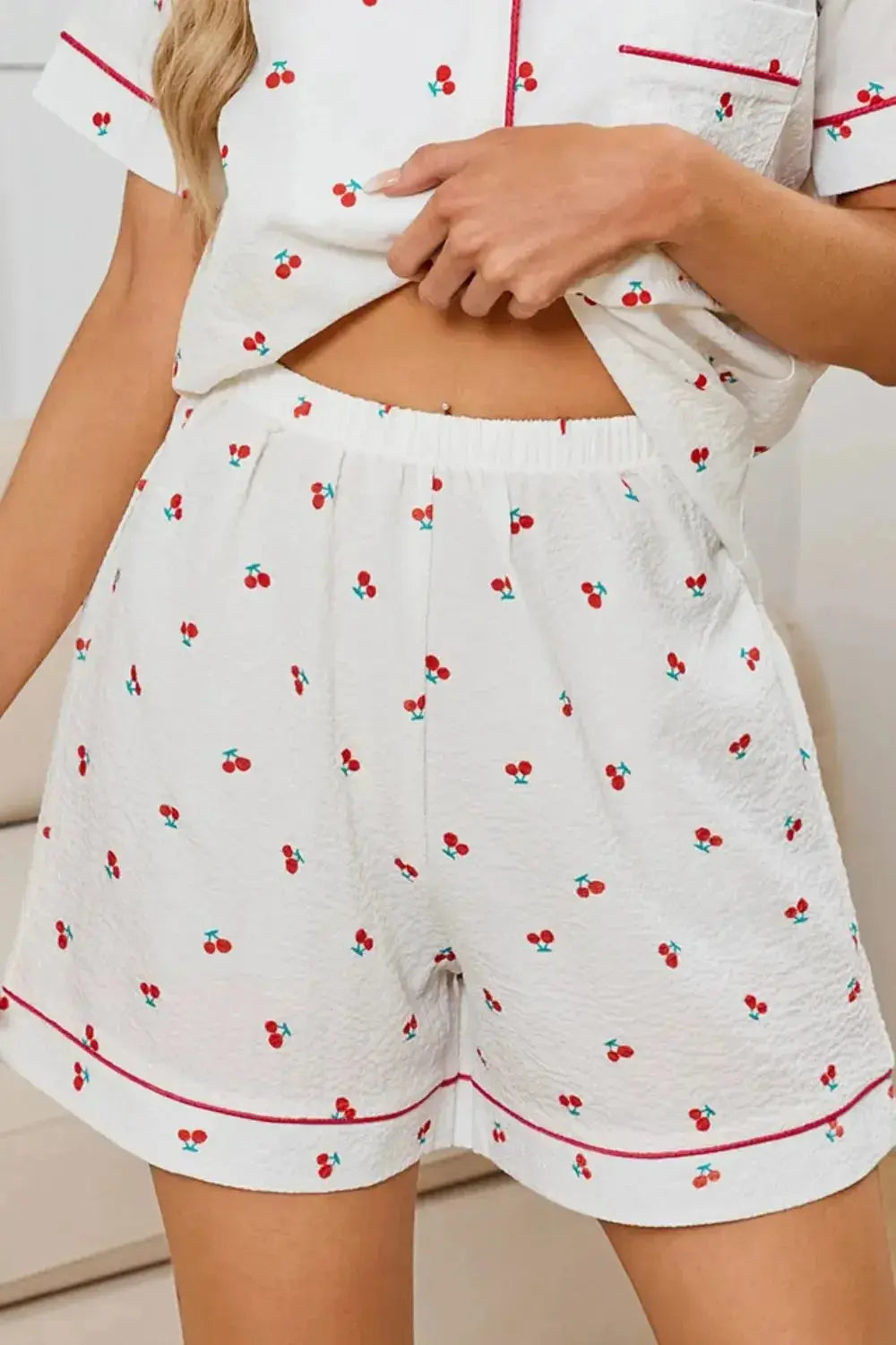Women's cheery print collared pajama top and shorts lounge set by Plush Fashion Hub, featuring a button-down pajama top and matching shorts.