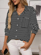 Women's classic striped long sleeve button-up shirt by Trendsi, ideal for versatile office wear, featuring a timeless design.