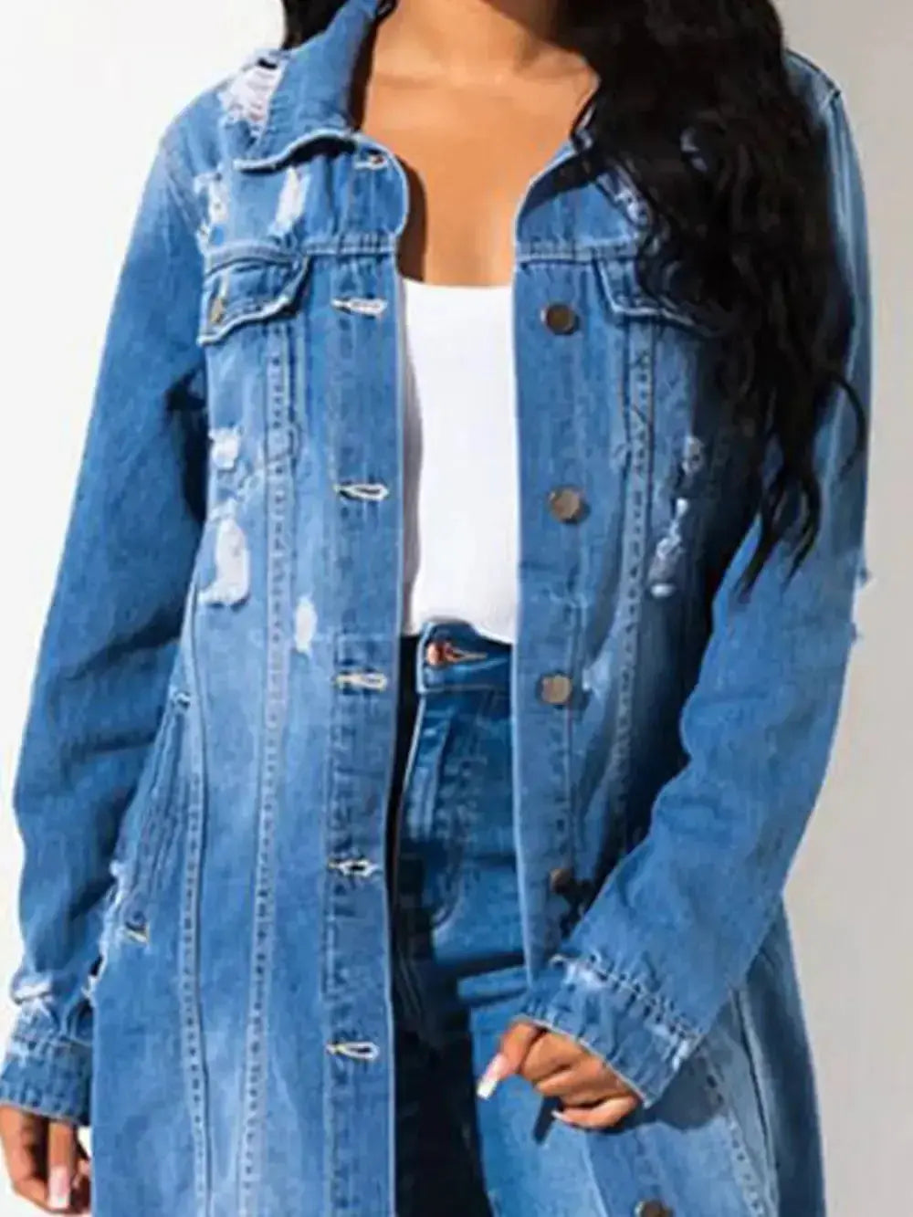 Women's distressed raw hem denim jacket with long sleeves, classic cotton jean style by Trendsi, shown on a model.