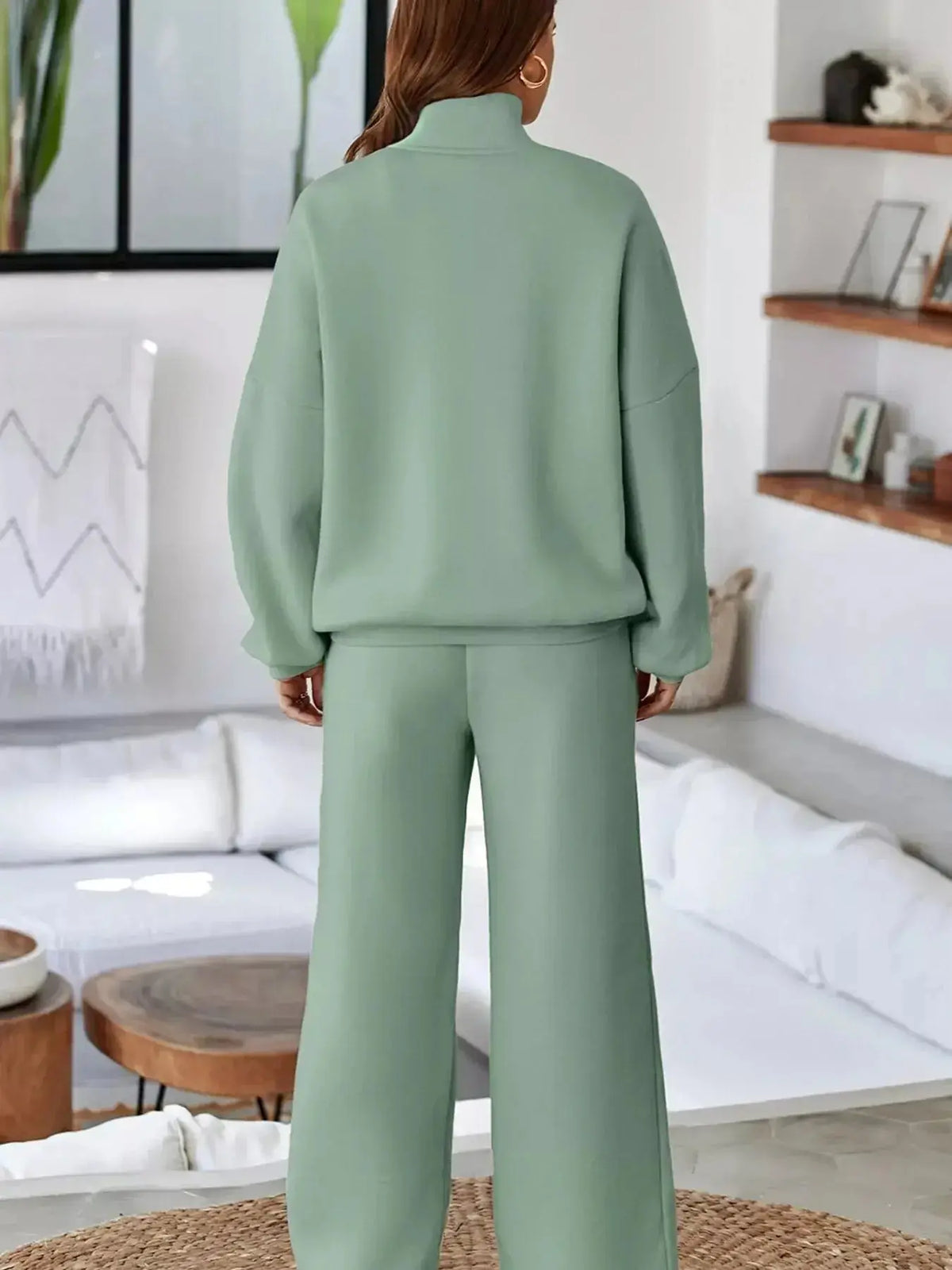 Women wearing Plush Fashion Hub's drop shoulder zip-up jacket and matching jogger lounge set, casual and comfortable for relaxing.