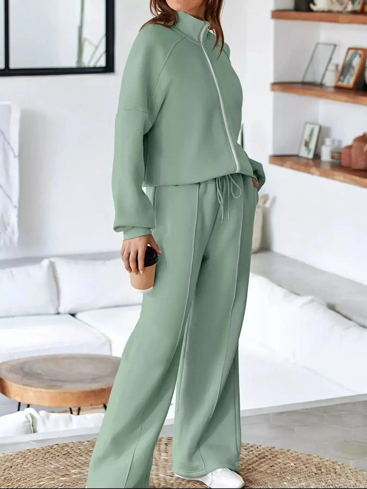 Women's drop shoulder zip-up jacket and jogger lounge set by Plush Fashion Hub, featuring a comfortable matching sweat suit.