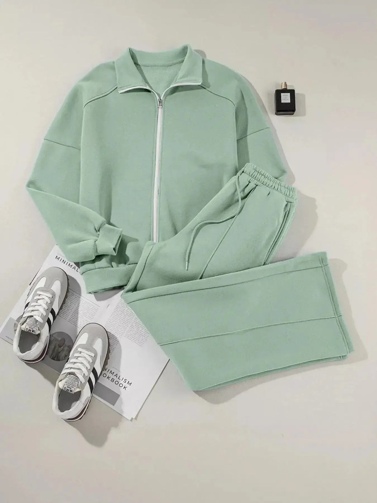 Women's plush fashion hub zip-up jacket and jogger lounge set, featuring a drop shoulder design and comfortable sweat suit style.