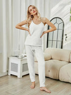 Women's fuzzy V-neck cami and pants lounge sleepwear set, cozy two-piece pajama set by Trendsi, featuring soft fabric and relaxed fit.