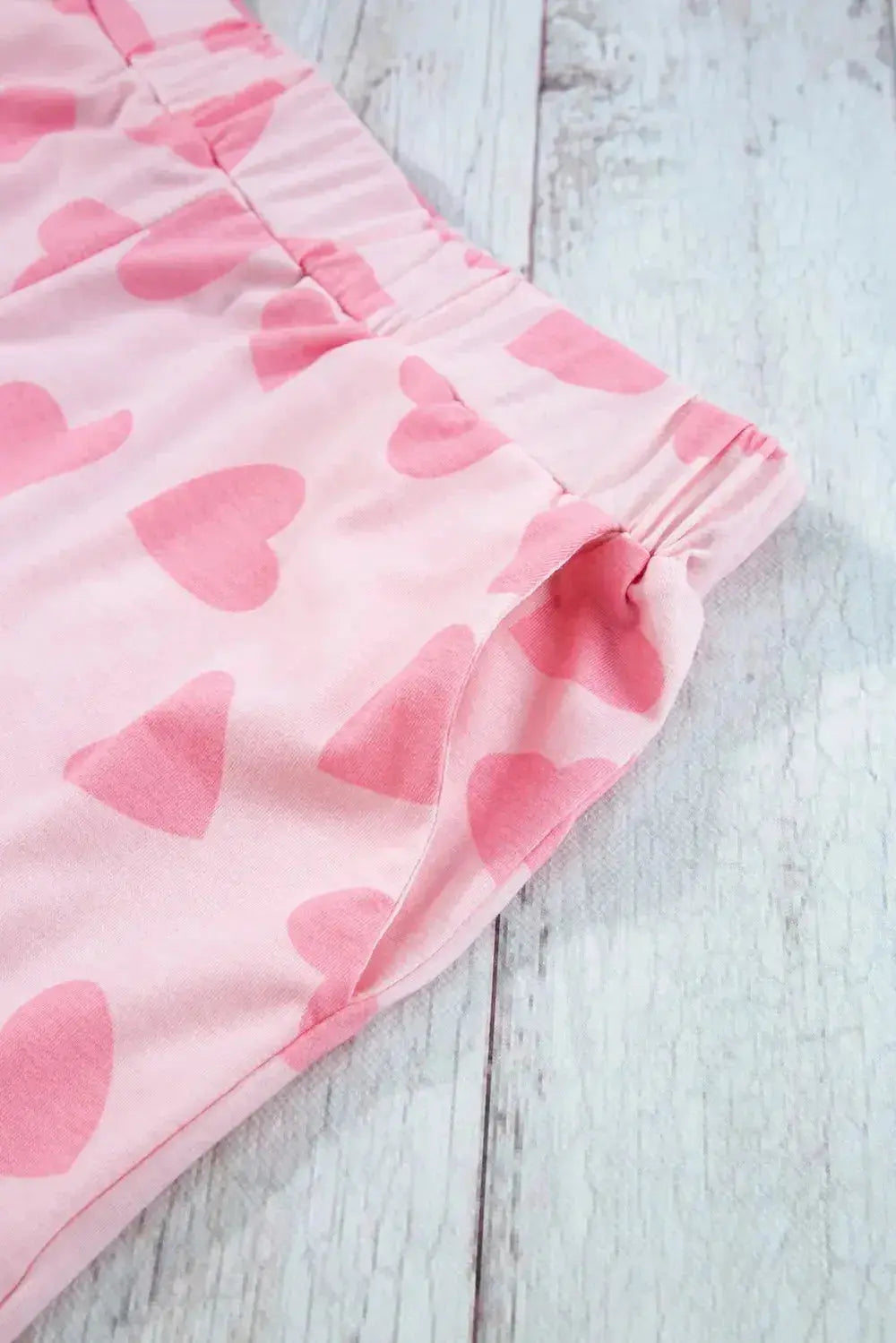 Women's heart print long sleeve pajama set by Trendsi, featuring cozy two-piece plush lounge pajamas with a stylish heart pattern.