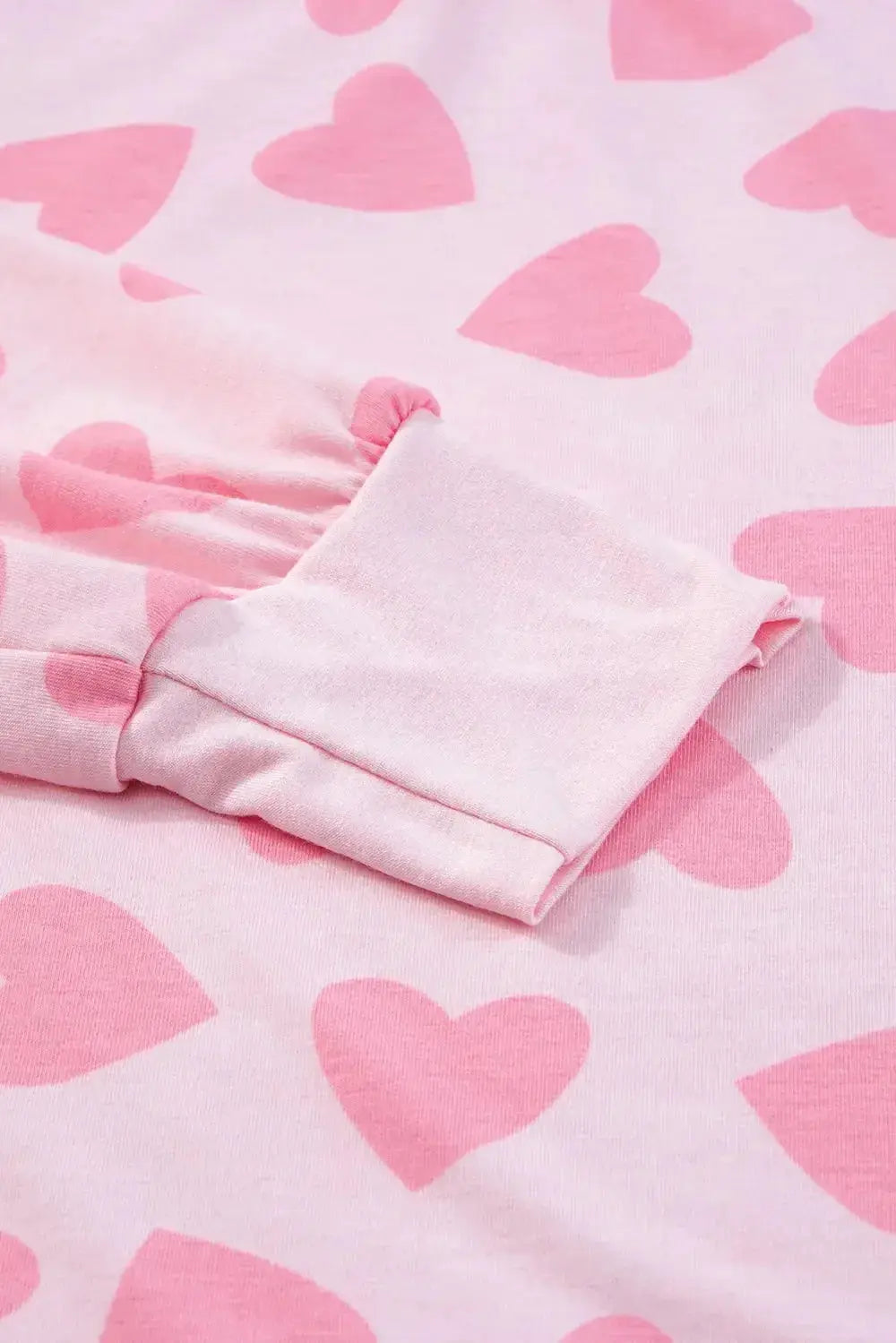 Women's heart print long sleeve pajama set featuring a cozy two-piece plush lounge sleepwear by Trendsi.