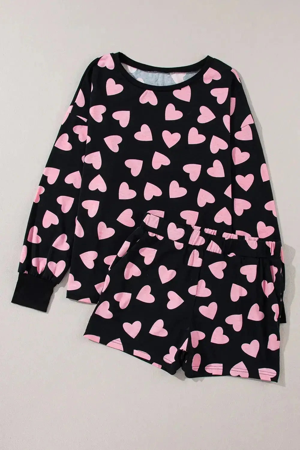 Women’s heart print long sleeve pajama set by Trendsi, featuring a cozy two-piece plush lounge pajamas with a charming heart pattern.