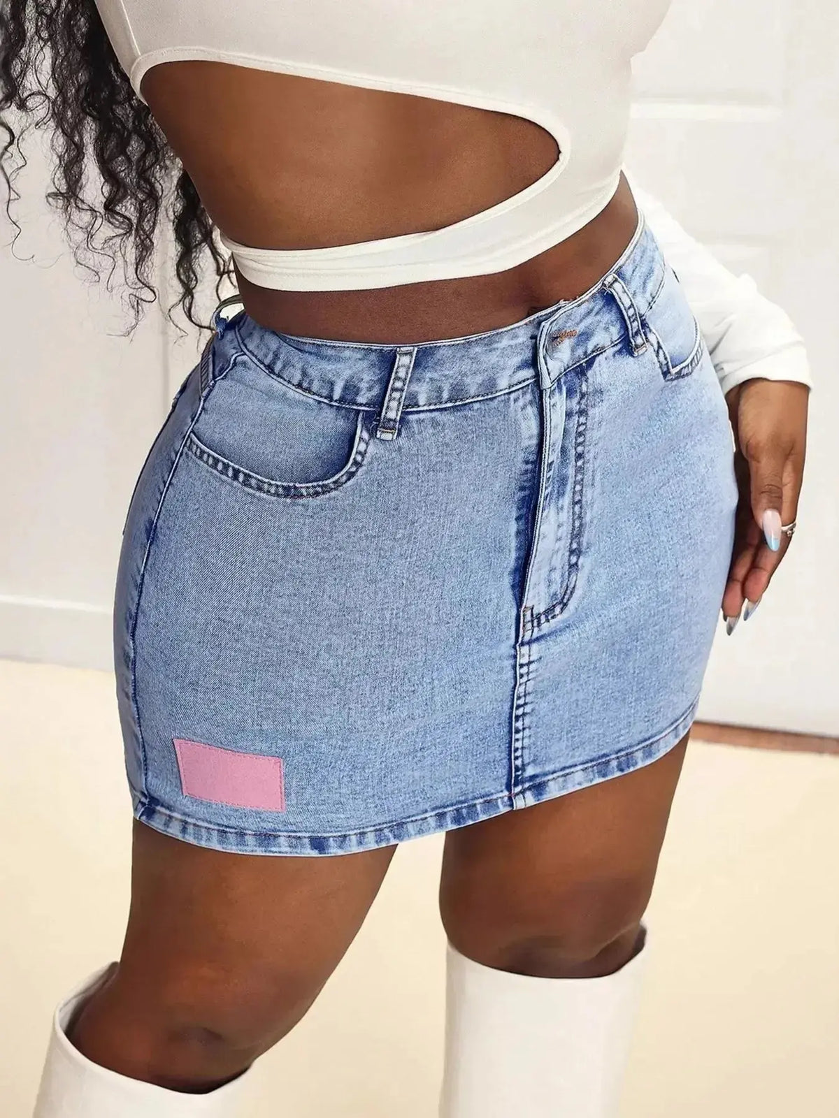 Women wearing a high-waisted stretch denim mini skirt by Plush Fashion Hub, showcasing its classic casual fit and trendy style.