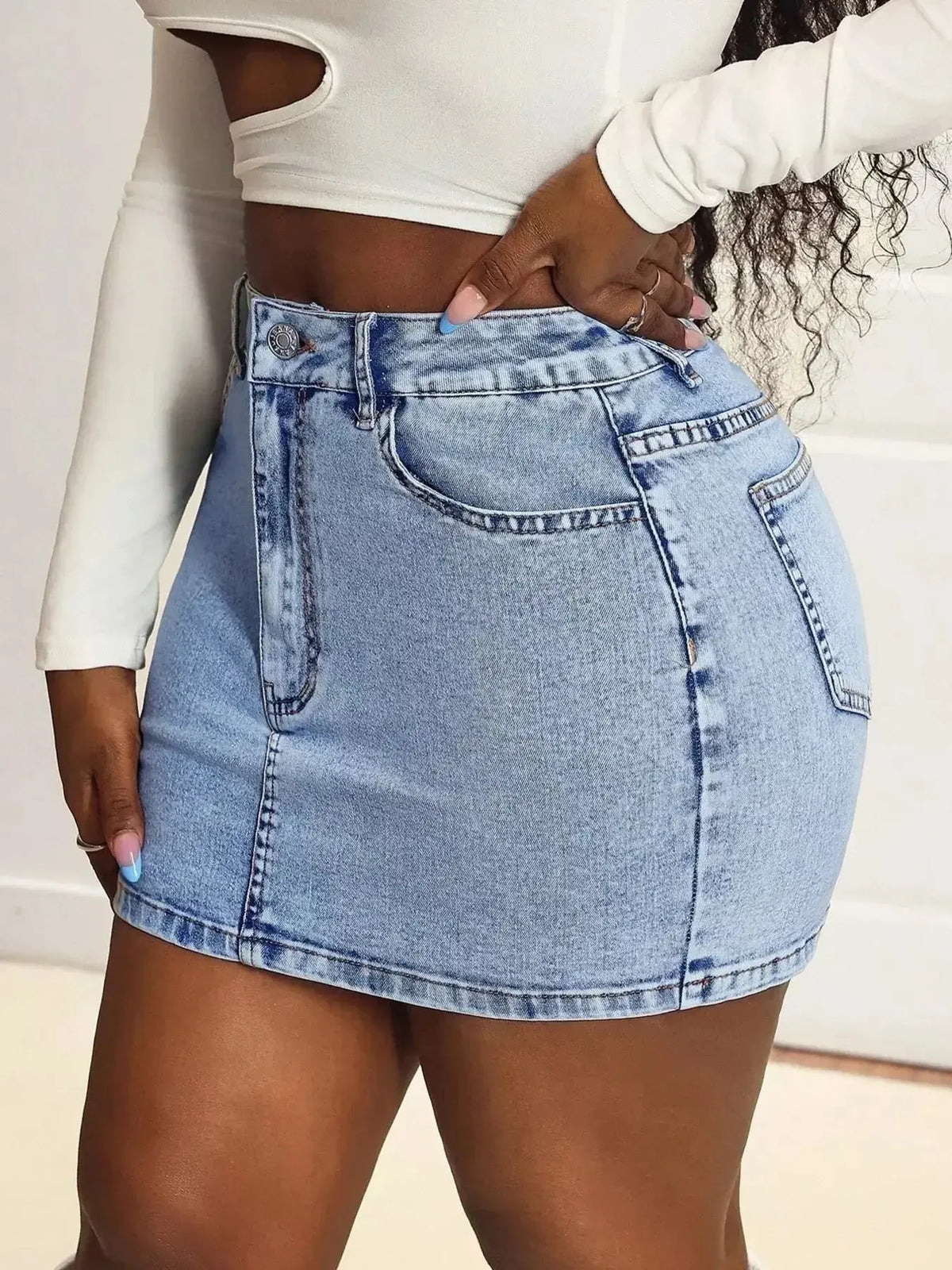 Women’s high-waisted stretch denim mini skirt with a classic casual fit, from Plush Fashion Hub, shown in a stylish, casual look.