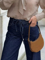 Women’s high-waisted tied loose fit flare jeans in relaxed denim, featuring a stylish silhouette and casual fit.
