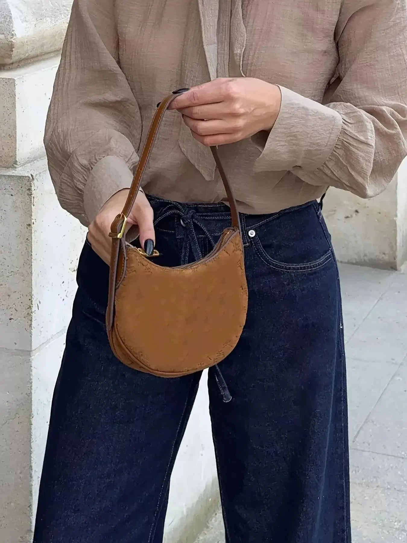 Women’s high-waisted tied loose fit flare jeans in relaxed denim, featuring a stylish silhouette and casual design.