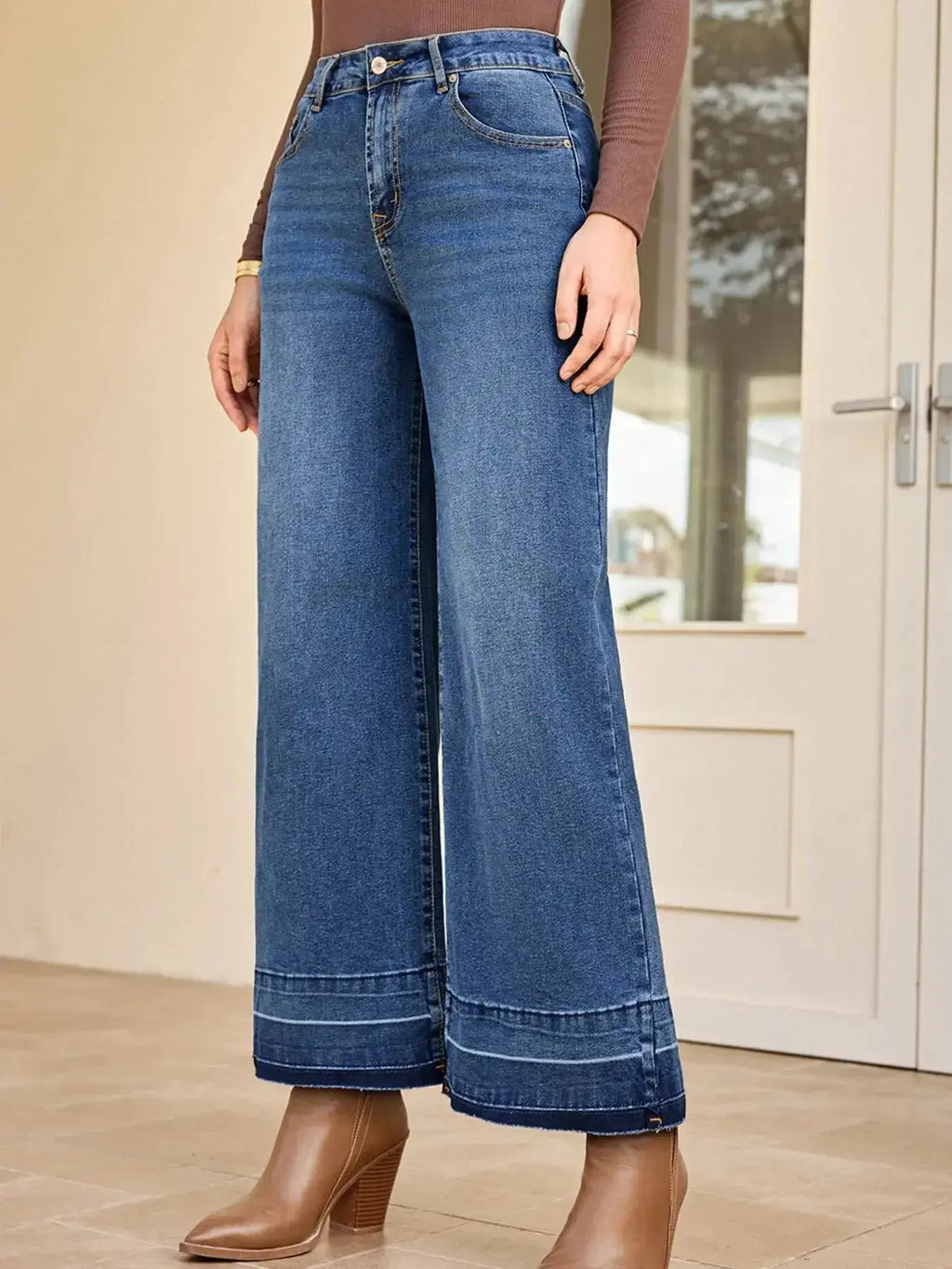 Women's high-waisted wide-leg washed denim jeans with classic relaxed fit, displayed on a model.