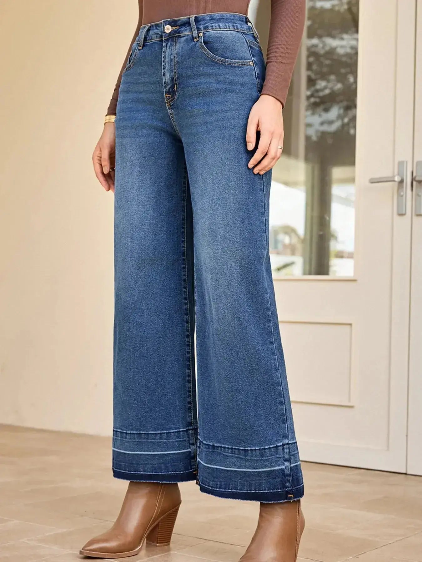 Women's high-waisted wide-leg washed denim jeans with classic relaxed fit, displayed on a model.