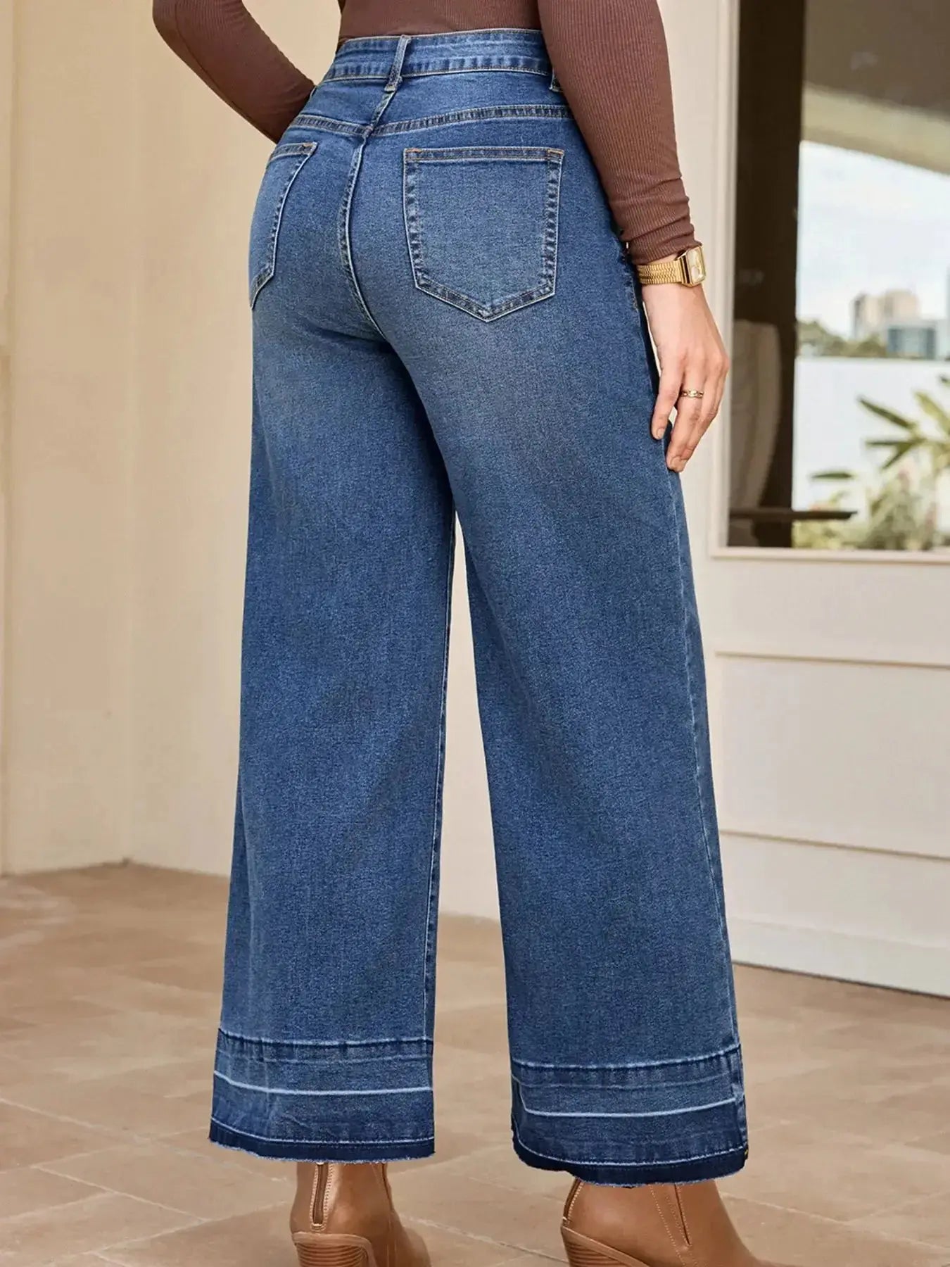 Women’s high-waisted wide-leg washed denim jeans with a relaxed fit, featuring classic denim styling and trendy design.