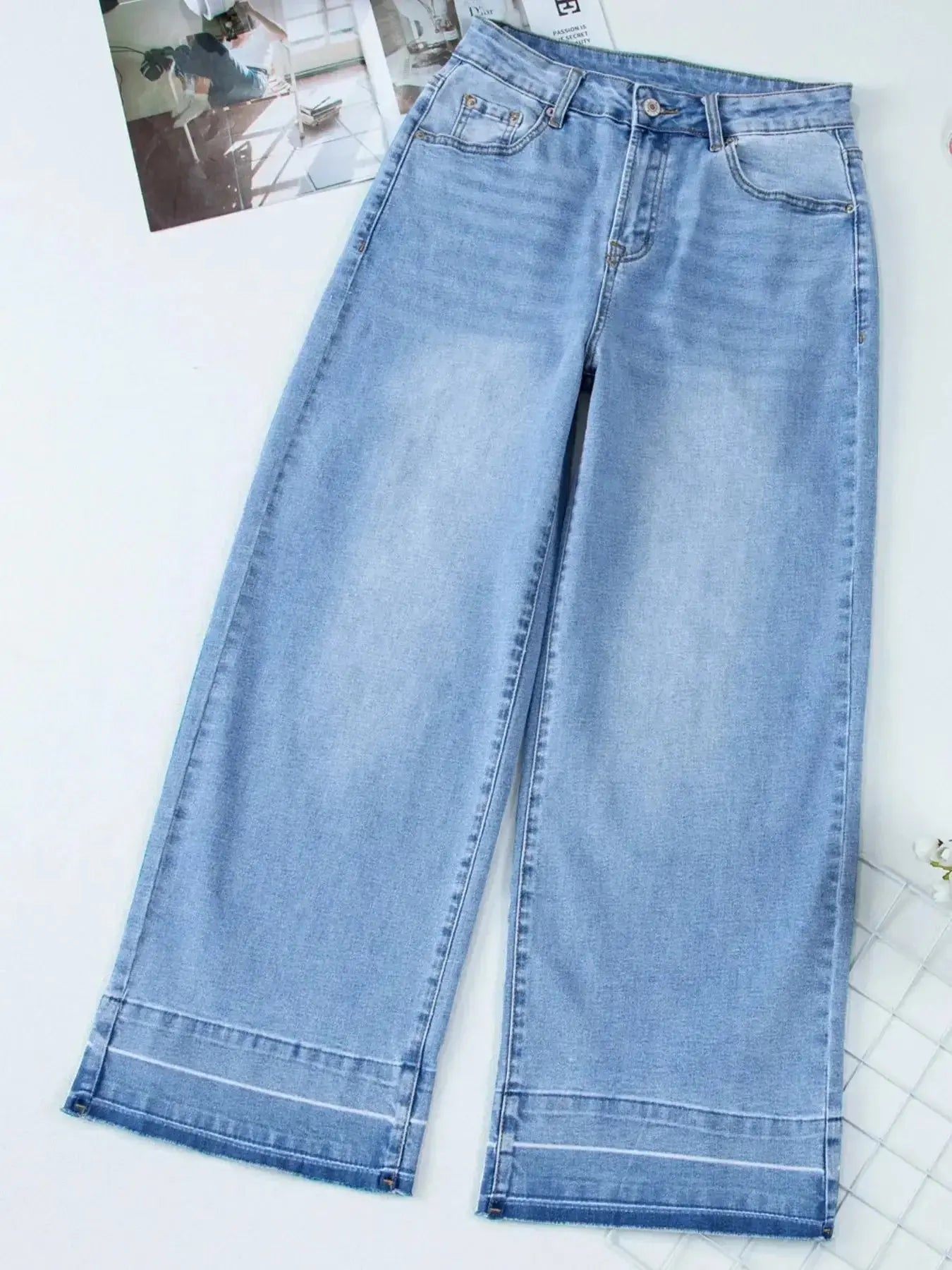 Women’s high-waisted wide-leg washed denim jeans with a relaxed fit, featuring classic style and trendy denim look.