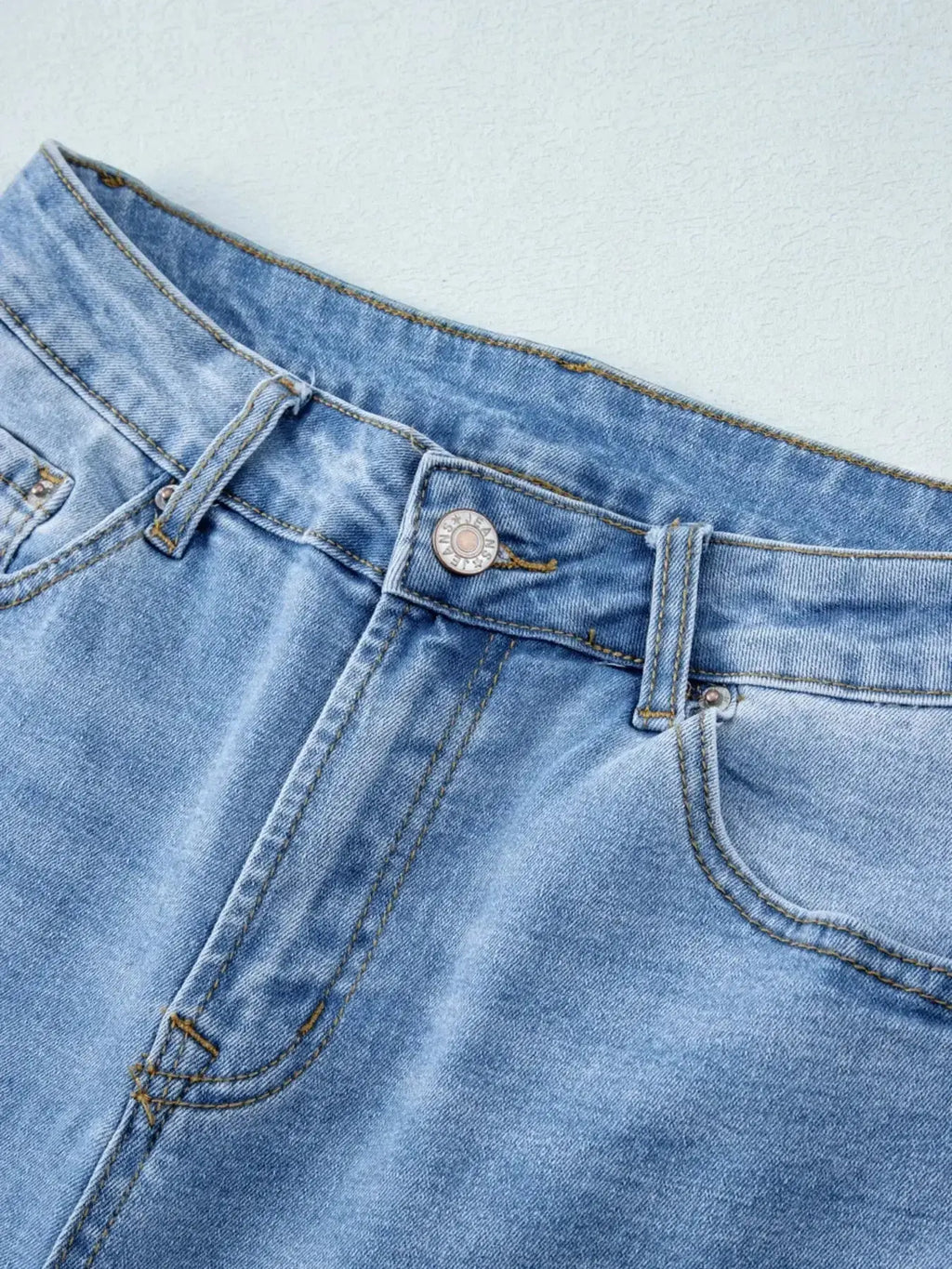 Women’s high-waisted wide-leg washed denim jeans with a relaxed fit, showing the stylish fit and distressed detailing.