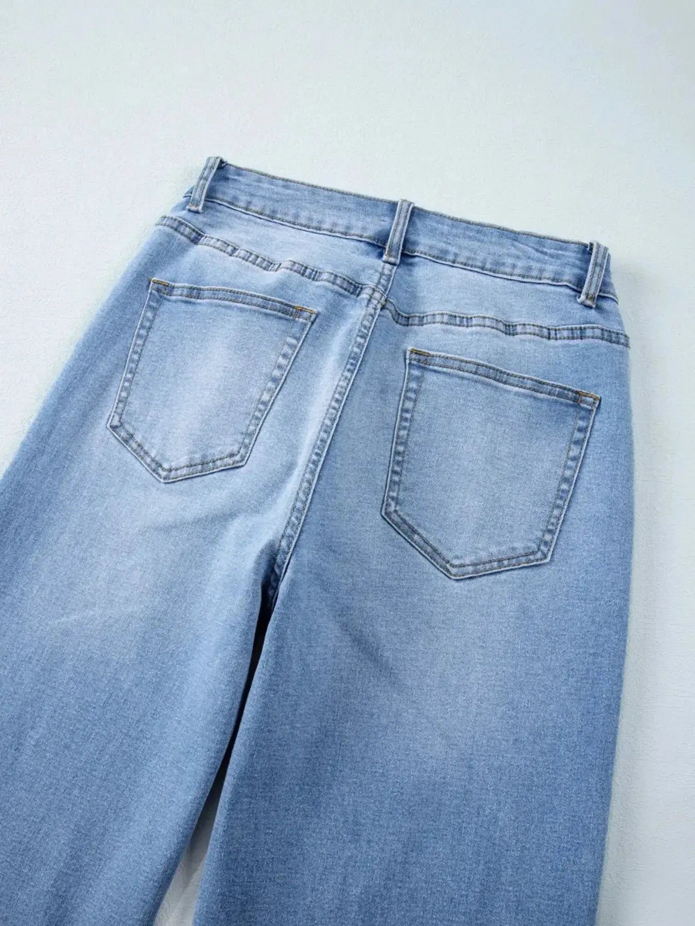 Women's high-waisted wide-leg washed denim jeans with a classic relaxed fit, featuring a stylish, casual look.