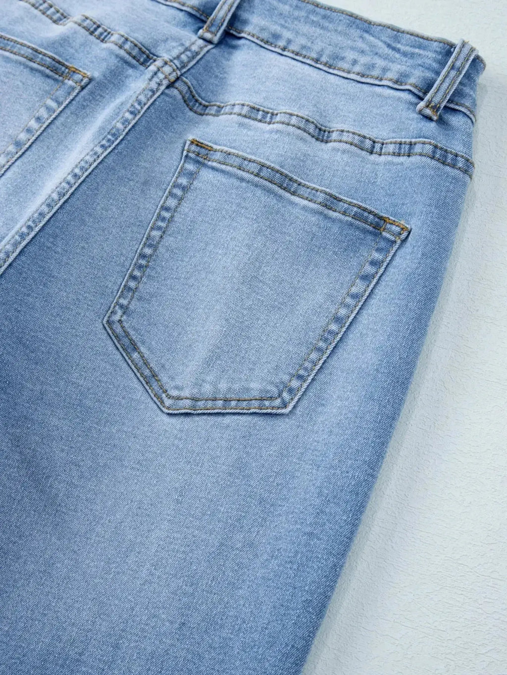 Women’s high-waisted wide-leg washed denim jeans with a relaxed fit, shown on a model in a casual pose.