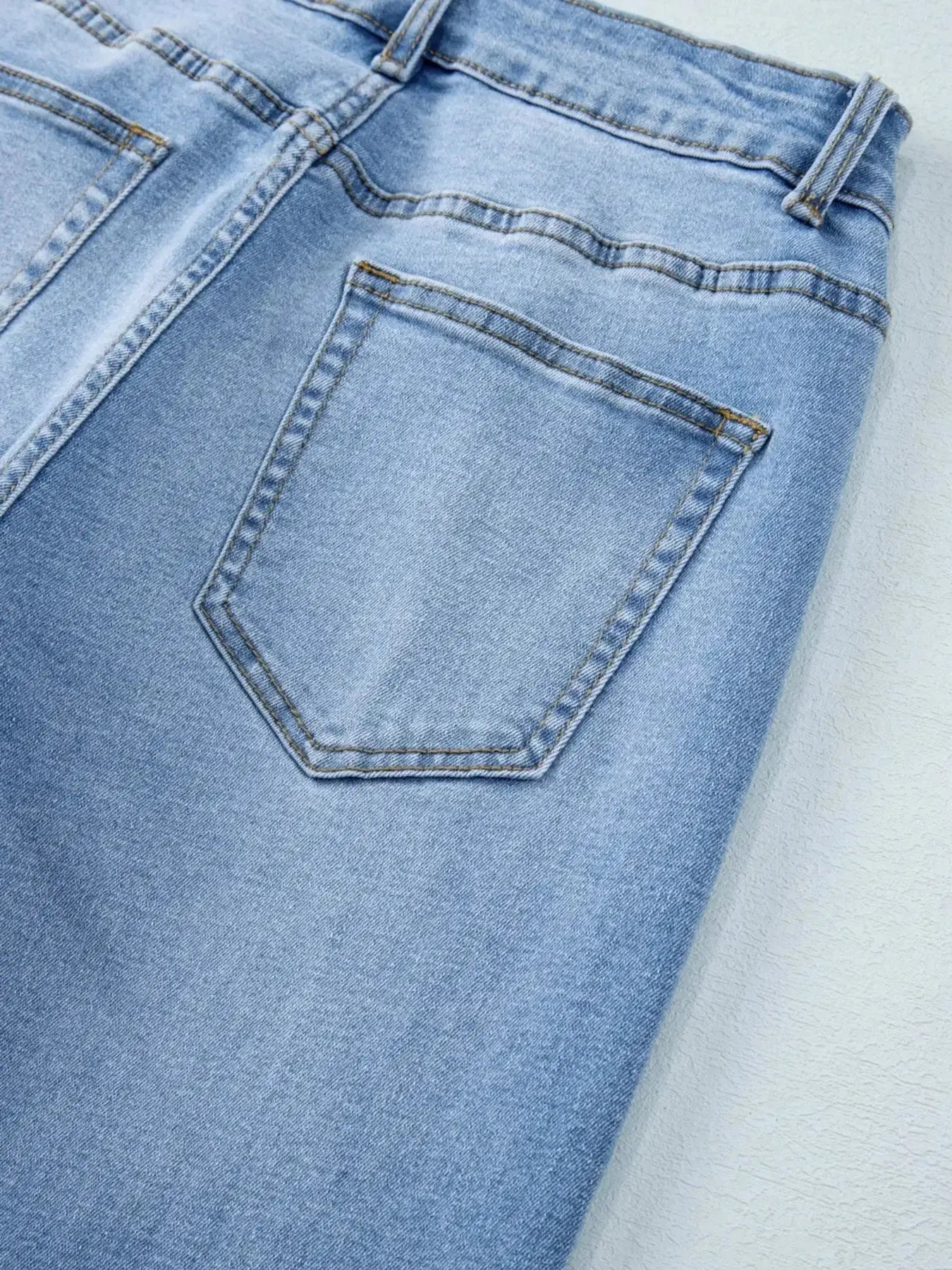 Women’s high-waisted wide-leg washed denim jeans with a relaxed fit, shown on a model in a casual pose.