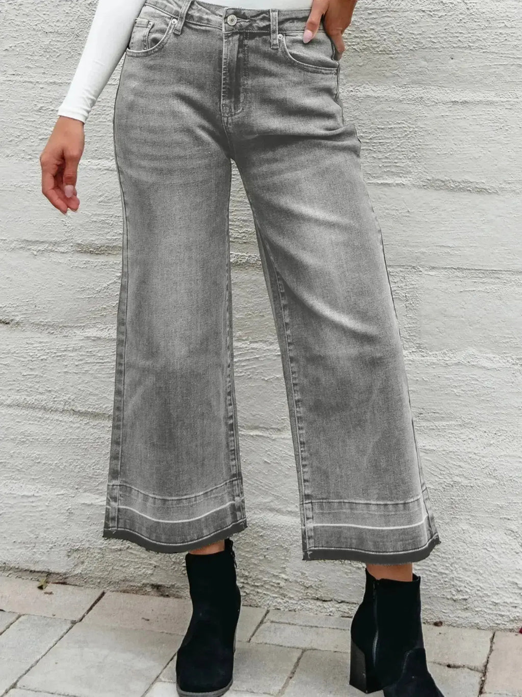 Women’s high-waisted wide-leg washed denim jeans with a relaxed fit, styled casually, by Trendsi.