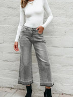 Women’s high-waisted wide-leg washed denim jeans in a relaxed fit, showcasing a casual, stylish look with subtle fading.