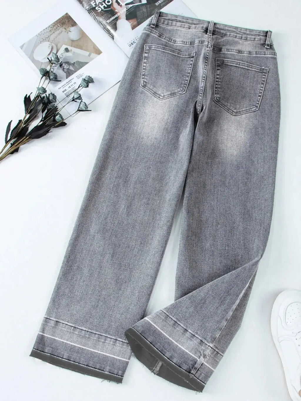 Women’s high-waisted wide-leg washed denim jeans with a relaxed fit, styled casually, by Trendsi.