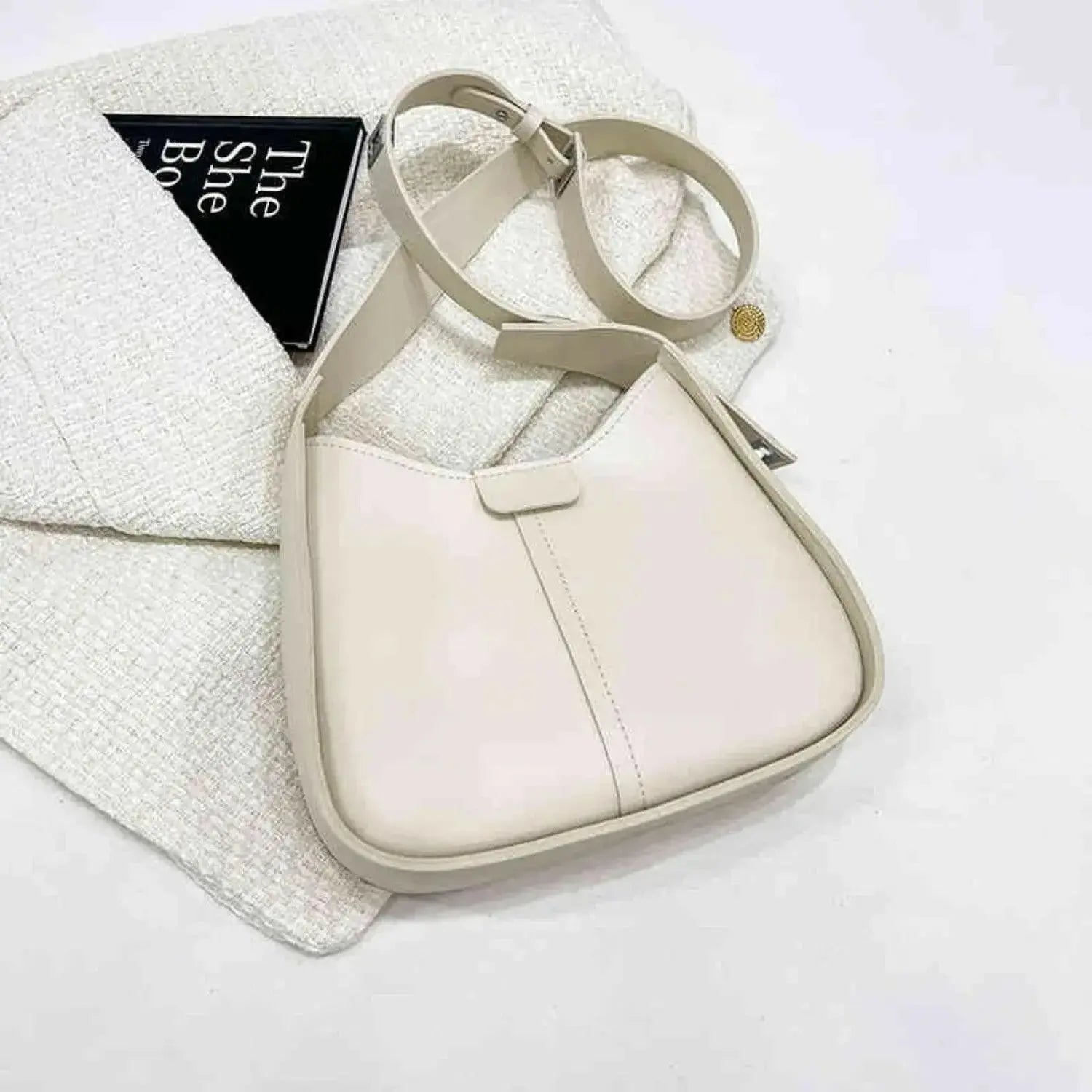 Women's textured vegan leather crossbody handbag with a sleek shoulder strap, versatile style from Plush Fashion Hub.