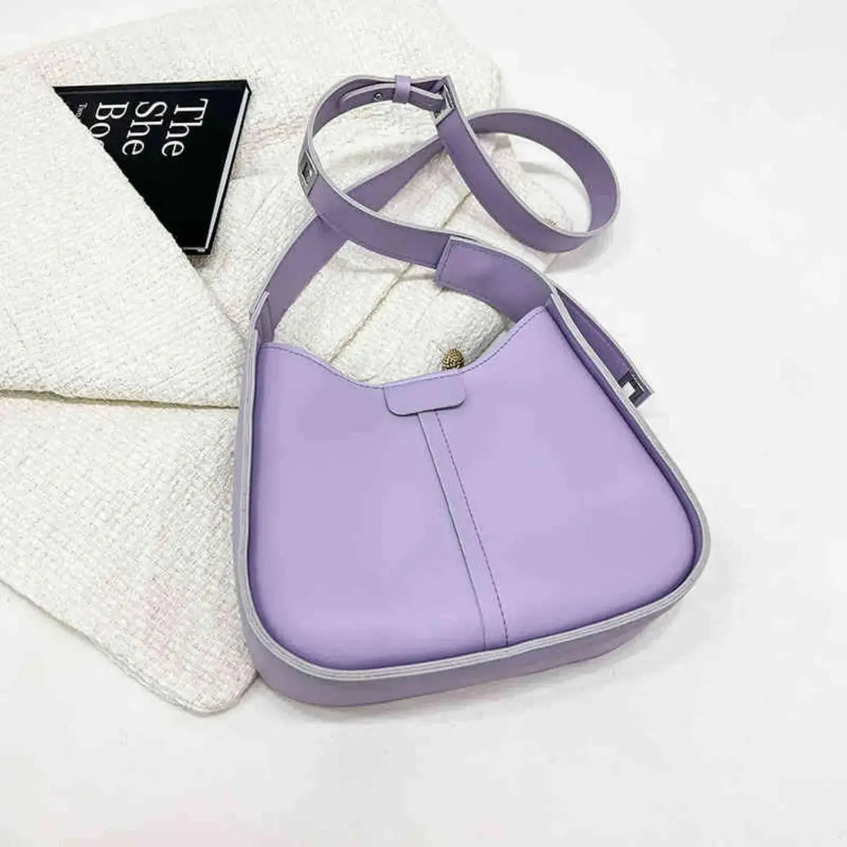 Women’s textured vegan leather crossbody handbag with versatile shoulder strap from Plush Fashion Hub, stylish and high-end design.