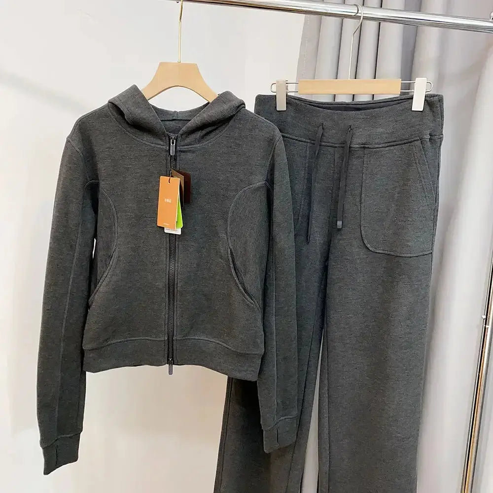 Women wearing Plush Fashion Hub hooded sweatshirt and wide-leg pants lounge set, comfortable casual sweatsuit ensemble.