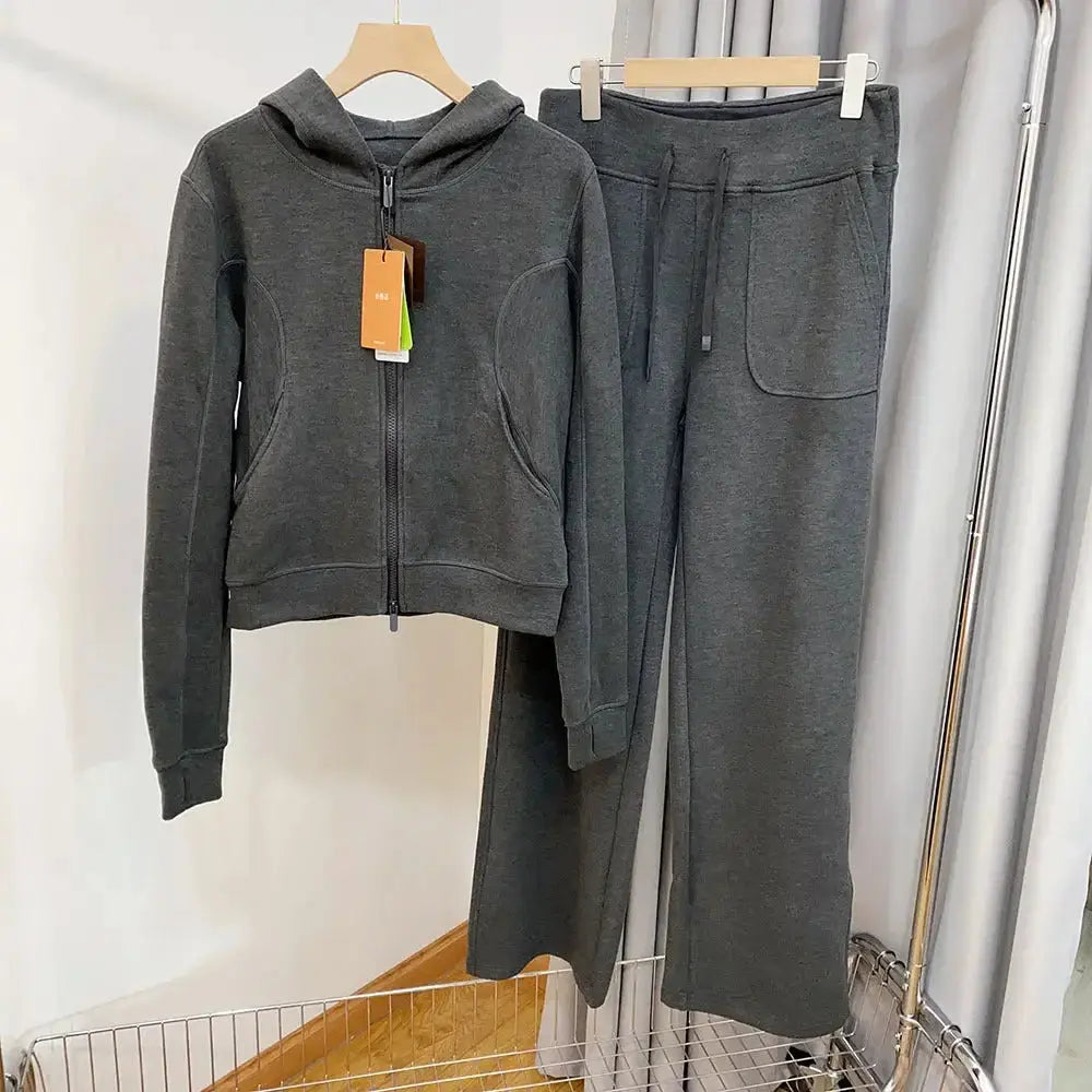 Women wearing a plush hooded sweatshirt and wide-leg pants lounge set, stylish and comfortable sweatsuit by Plush Fashion Hub.