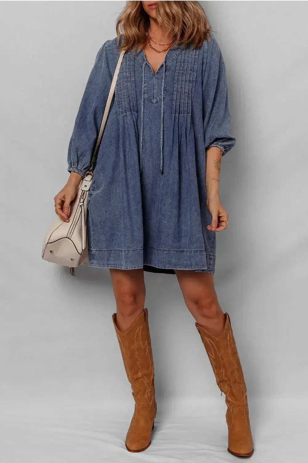 Women’s long sleeve tie neck denim mini dress by Trendsi, made of soft cotton with a casual style and classic denim look.