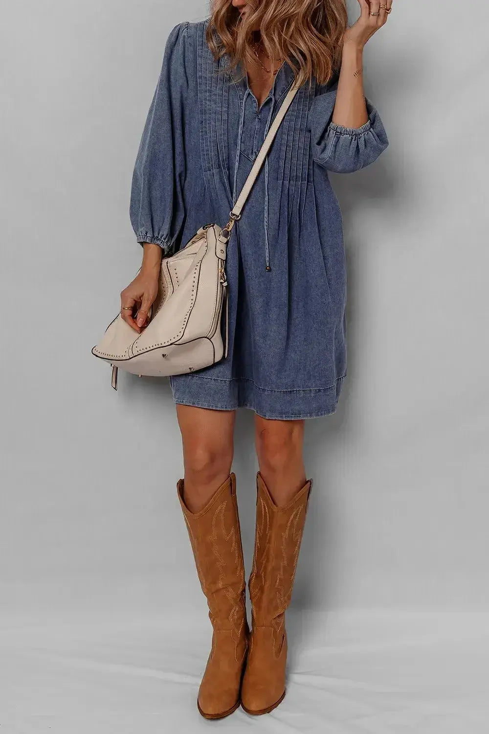 Women’s long sleeve denim mini dress with tie neck, soft cotton fabric, casual style by Trendsi, shown in a relaxed fit.