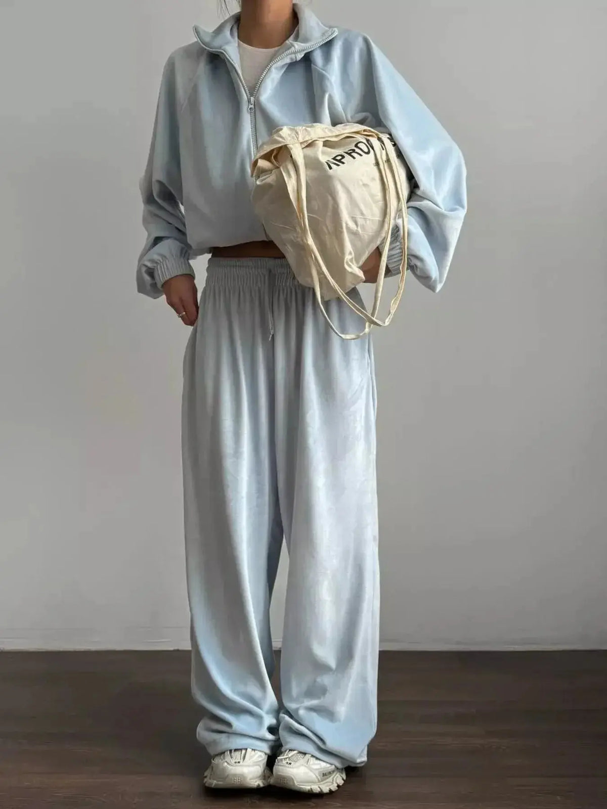 Women’s long sleeve zip-up jacket and pants lounge set by Plush Fashion Hub, shown in a cozy, matching fabric ensemble.